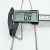 Digital caliper showing the depth of silver tubular link as 0.8mm