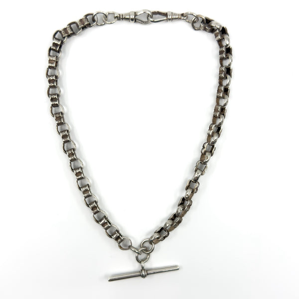 Sterling silver Albert chain coiled, showing both dog clips and the chunky fancy link design.