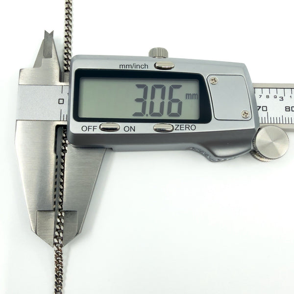 Digital calipers measuring the sterling silver flat curb chain at approximately 3.06mm width.