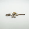 Sterling silver charm with cross, key and gold heart shown lying flat