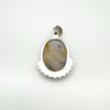 Back of chunky sterling silver pendant showing agate and smooth silver frame