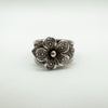 Front view of chunky sterling silver ring with raised flower and leaf detail
