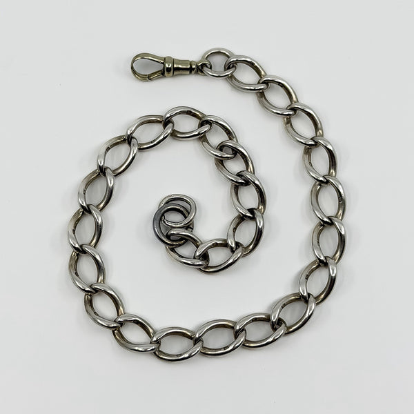 Chunky antique sterling silver oval link Albert chain with large dog clip fastening laid flat