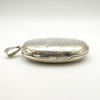 Side profile of large silver locket with secure hinge