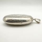 Side view showing engraved edge of oval locket