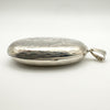 Side view showing engraved edge of oval locket