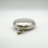 Top view showing large silver bail and engraved edge