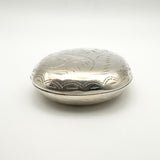 Front facing view of large engraved silver locket