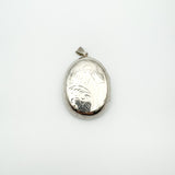 Front facing view of large engraved silver locket