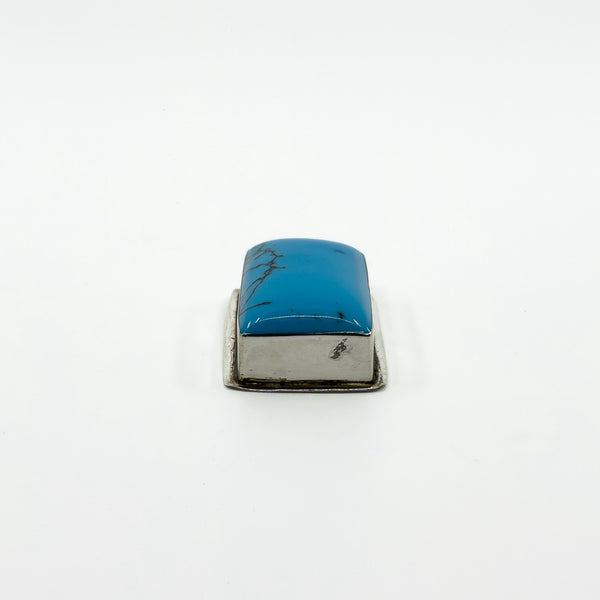Side profile of chunky sterling silver turquoise pendant showing the raised rectangular stone setting