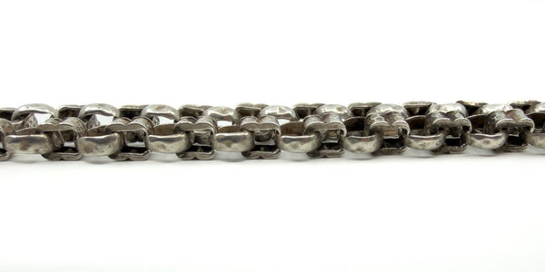 Close-up of the chunky fancy links on the sterling silver Albert chain, showing texture and link shape.