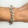 Secondhand sterling silver bracelet styled on wrist with bold twisted links