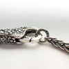 Detailed view of Trollbeads clasp connected to 925 LAA stamped ring
