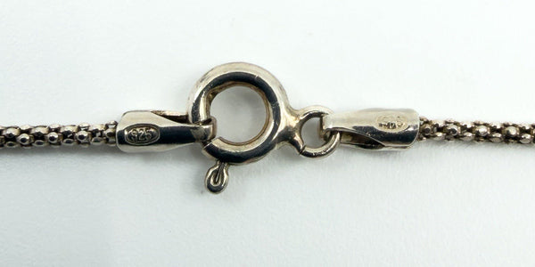 Close-up of the spring ring clasp and end fittings showing 925 stamp on the sterling silver chain.