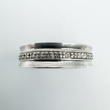 Close-up of 14 round cut diamonds set in a sterling silver half hoop band