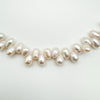 Close-up of white baroque pearls on sterling silver bracelet