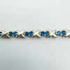 Detail of prong set blue CZs and X-shaped silver links