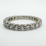 Close-up of prong-set round diamonds in platinum eternity band