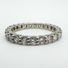 Close-up of prong-set round diamonds in platinum eternity band