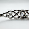 Detailed shot of 925 and CZ stamp markings behind the open Celtic knotwork