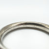 Macro view of inner band showing wear and a faint, possibly incomplete maker's mark