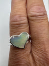 Sterling silver heart-shaped mother of pearl ring close-up worn on hand