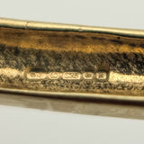 Birmingham hallmark with 375 and blurred date letter on gold bangle