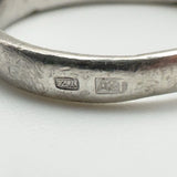 Detailed view of maker’s mark and sponsor’s stamp on vintage sterling silver ring