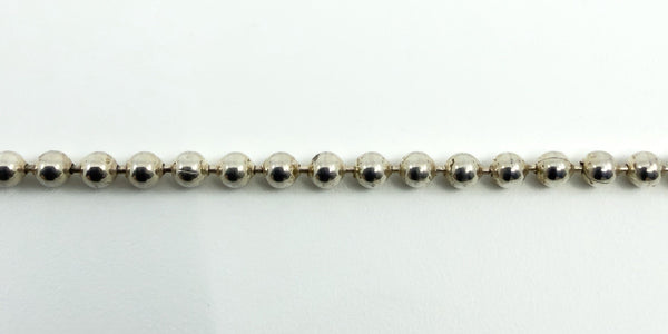 Detail of the beaded ball links on a sterling silver chain necklace, showing the polished finish.