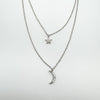 Detailed view of crescent moon and star charms on sterling silver chain