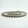 Curb chain coiled to show bolt ring clasp and sturdy links in sterling silver.