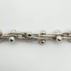 Close-up of twisted sterling silver links with polished ball accents