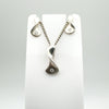 Matching diamond necklace and earrings set in sterling silver on display