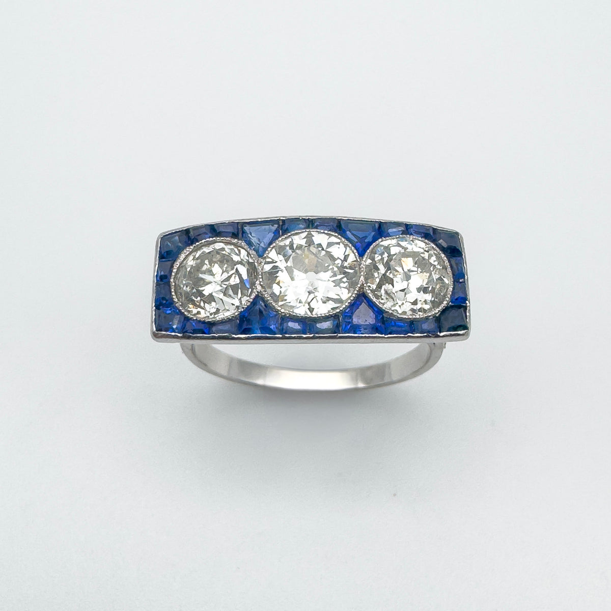 Diamond and sapphire three stone trilogy ring