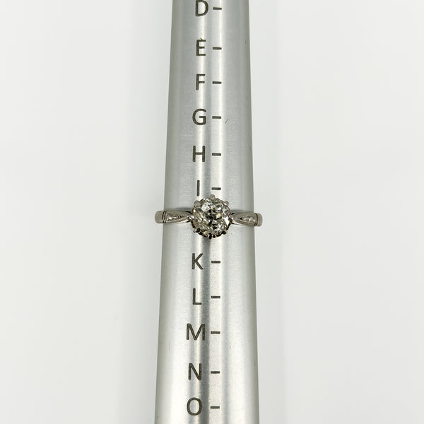 Antique platinum old-cut diamond solitaire ring shown on a ring size mandrel
