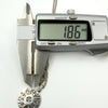 Digital calipers showing 1.86mm measurement on sterling silver History of Ireland pendant.