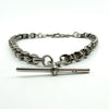 Close-up of one dog clip fitting on the sterling silver Albert chain, showing wear and construction.