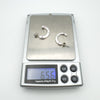 Pair of sterling silver earrings with pink sapphires and diamond weighing 6.56g on digital scale