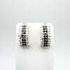 Black and white cubic zirconia earrings on white display stand