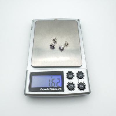 Amethyst earrings on jewellery scale showing combined weight of 1.62g