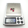 Pink fire opal stud earrings weighing 2.54g on digital scale