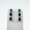 Close-up of gemstone drop earrings in sterling silver on display stand