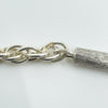 Detailed photo of silver end cap and twisted chain construction