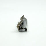 Close side view of pearl cluster end on the sterling silver bar brooch with paste accents.