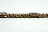 Side view of the antique 9ct rose gold Albert chain showing engraved bar links and faceted oval links