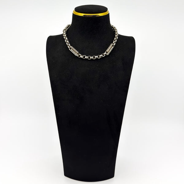Antique sterling silver Albert chain shown on display bust with engraved bars and faceted round links