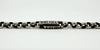 Close up of chunky engraved bar and faceted cut round links on antique sterling silver Albert chain
