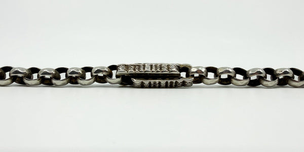 Close up of chunky engraved bar and faceted cut round links on antique sterling silver Albert chain