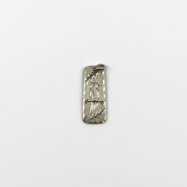 Small vintage sterling silver ingot pendant with bird and leaf engraving to the front.