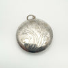 Close-up of foliate detail on sterling silver secret locket pendant